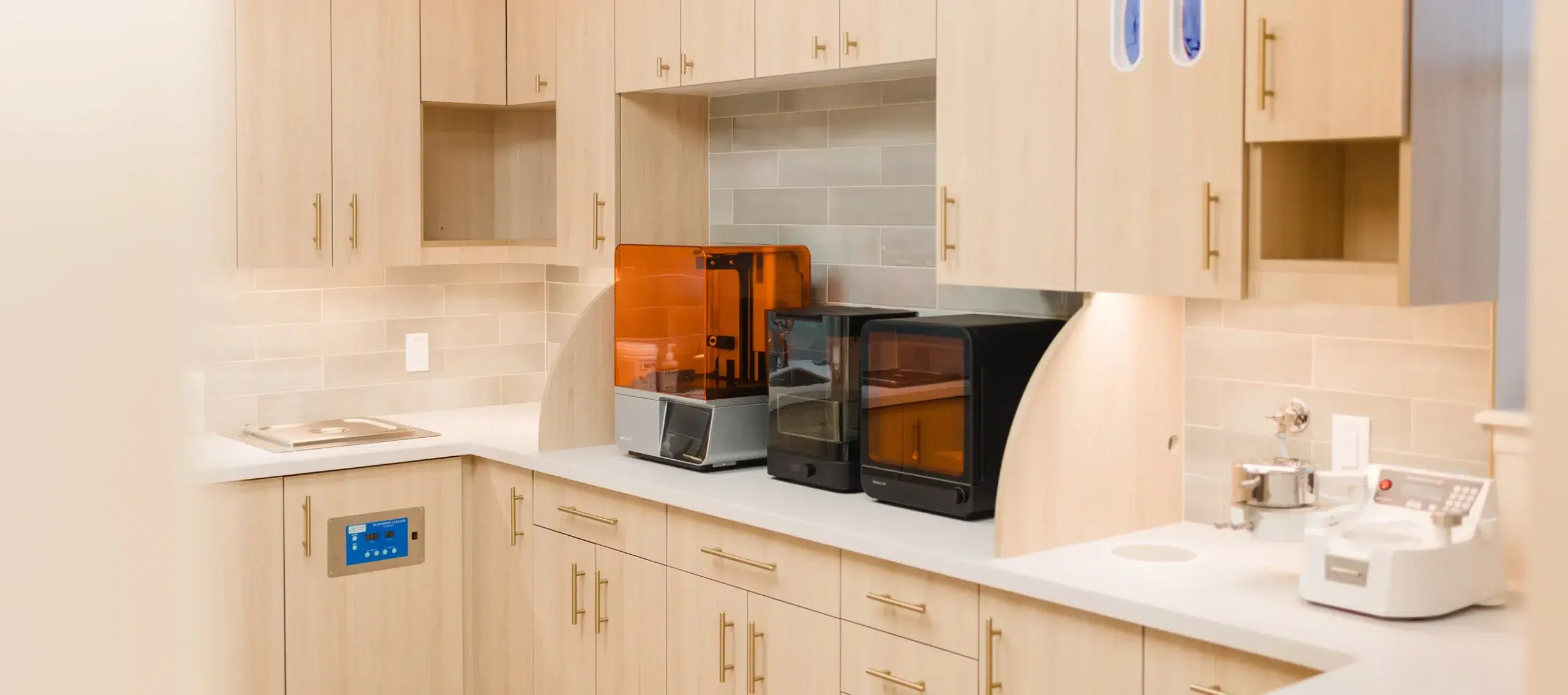 Bright orthodontic treatment area with light wood cabinetry